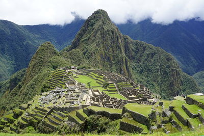 Aerial view of green mountains against sky