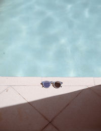 High angle view of sunglasses on poolside