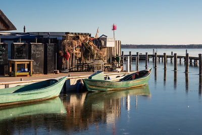 Boats moored at harbor