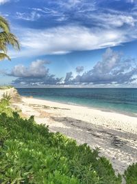 View of beach against cloudy sky