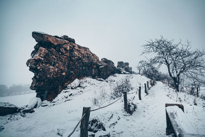 Snow covered land against sky