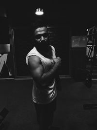 Young woman standing in illuminated room