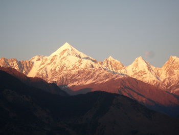 Scenic view of snowcapped mountains against clear sky