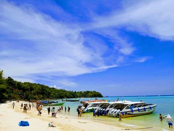 People on beach against sky