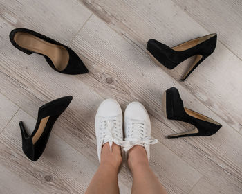 Low section of person wearing shoes on floor