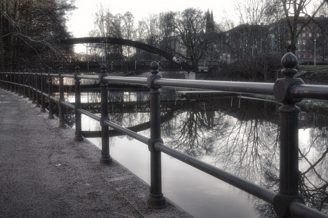 BRIDGE OVER RIVER BY TREES