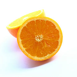 Close-up of orange slice against white background