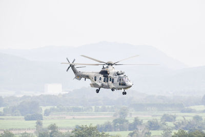 Helicopter flying in sky