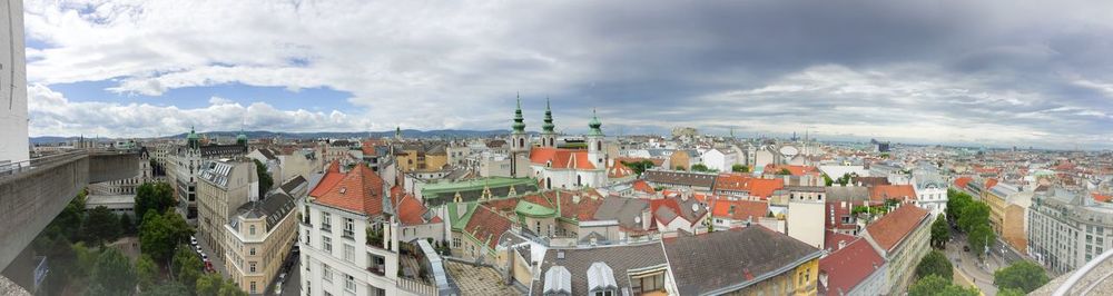 High angle shot of townscape against cloudy sky