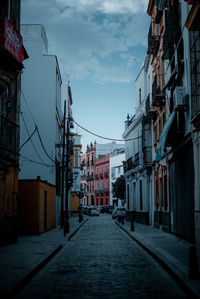 Empty alley amidst buildings in city