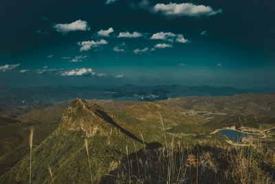 Aerial view of landscape against cloudy sky