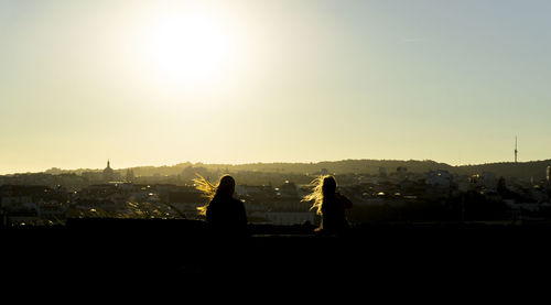 Silhouette cityscape against clear sky during sunset