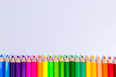 Close-up of colored pencils against white background