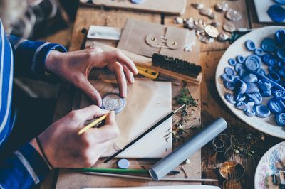 Midsection of man working on table