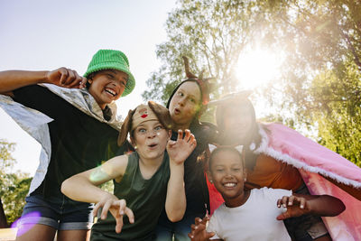 Portrait of happy children gesturing and making faces while playing together at summer camp