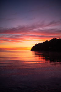 Scenic view of sea against romantic sky at sunset