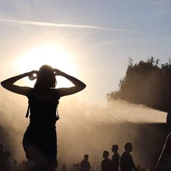 Silhouette people against sky during sunset