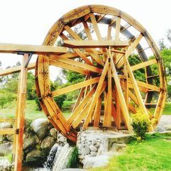 View of wooden structure by river against sky