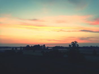 Scenic view of landscape against sky at sunset