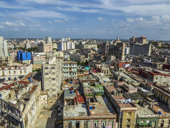 Cityscape against cloudy sky