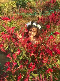 Portrait of woman in red flowering plants