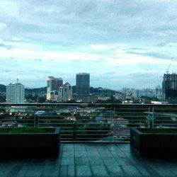 Cityscape against cloudy sky