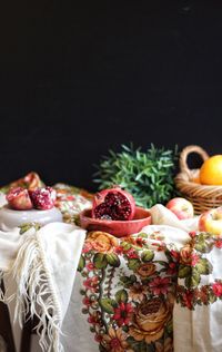 Close-up of fruits in basket against black background