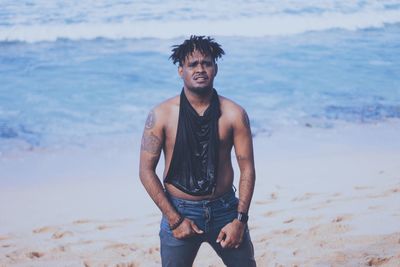 Young man standing on beach