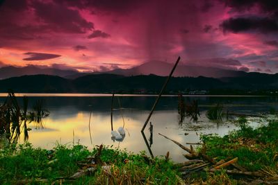 Scenic view of lake against sky during sunset