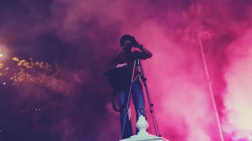 Low angle view of people against sky