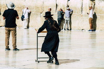 Rear view of people walking on floor