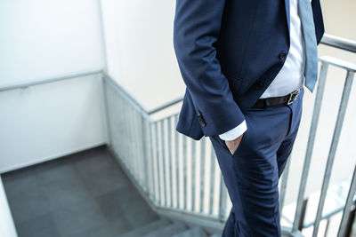 Midsection of man standing in front of office building