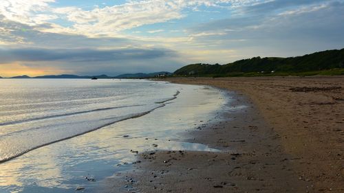 Scenic view of beach against sky during sunset