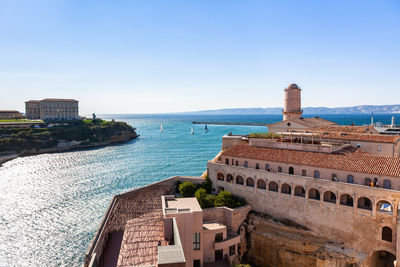 Panoramic view of sea and buildings against sky