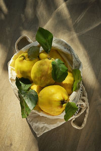 Freshly harvested quinces cydonia oblonga and grocery shopping bag