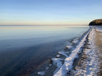 Scenic view of sea against clear sky during winter