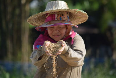 Portrait of woman wearing hat standing outdoors