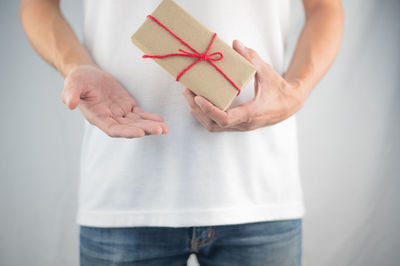 Midsection of a woman holding camera in box