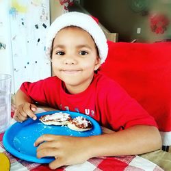 Portrait of boy sitting at home