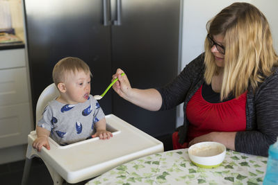 Mother feeding son