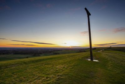 Scenic view of field against sky during sunset