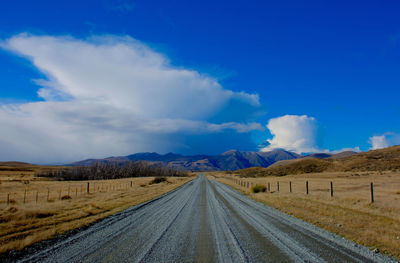 Empty road along countryside landscape