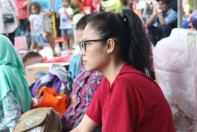 Side view of woman in eyeglasses looking away outdoors