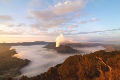 View of volcanic landscape against cloudy sky