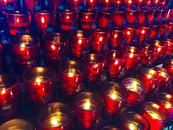 Low angle view of lit candles in temple