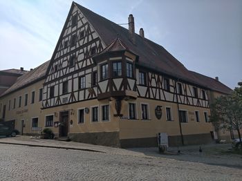 Building by road against sky