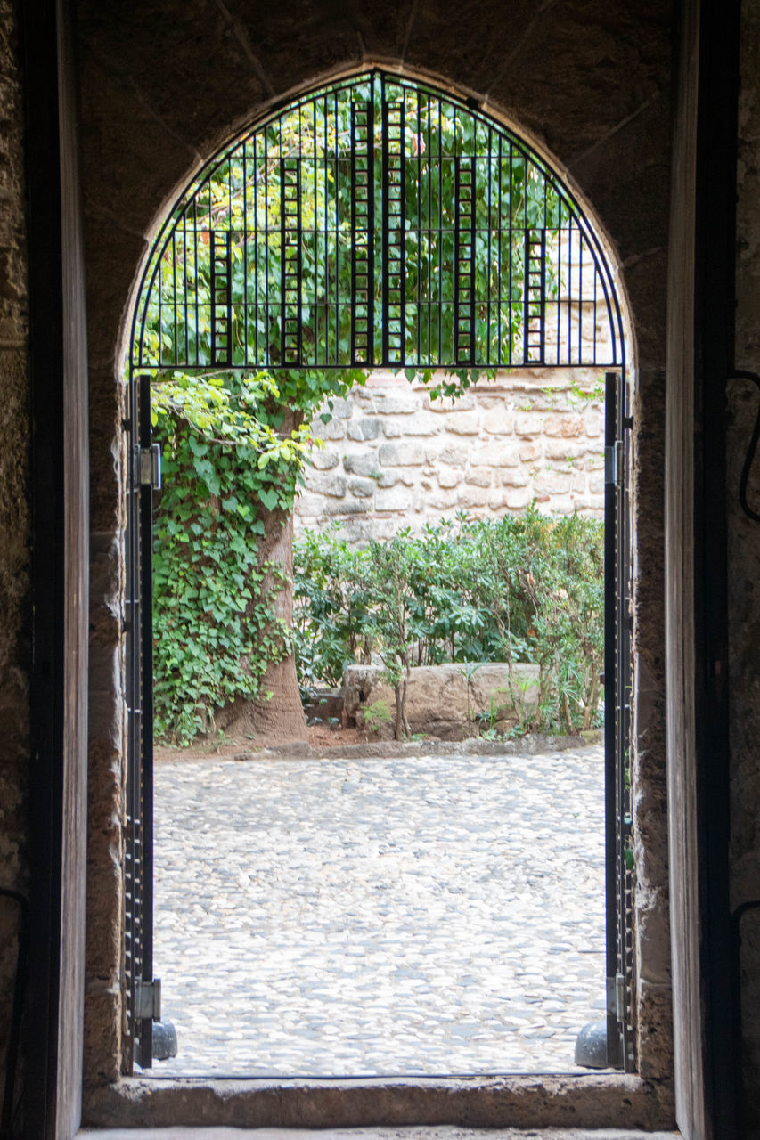 arch, architecture, window, built structure, no people, day, plant, estate, indoors, building, history, entrance, nature, tree, the past, house, door, open, water, interior design, home, green, iron, old