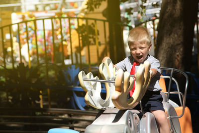 Cute boy playing with toy on playground