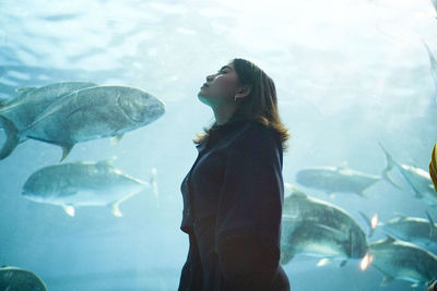 Side view of woman holding fish