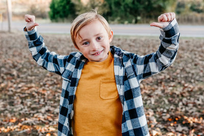 Portrait of smiling boy standing outdoors